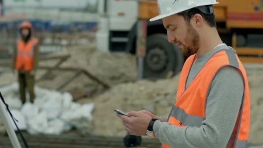 worker reviewing incident on mobile